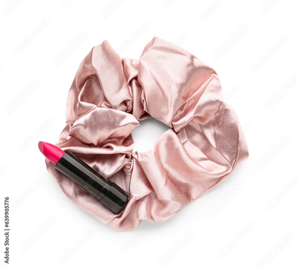Silk scrunchy and lipstick on white background
