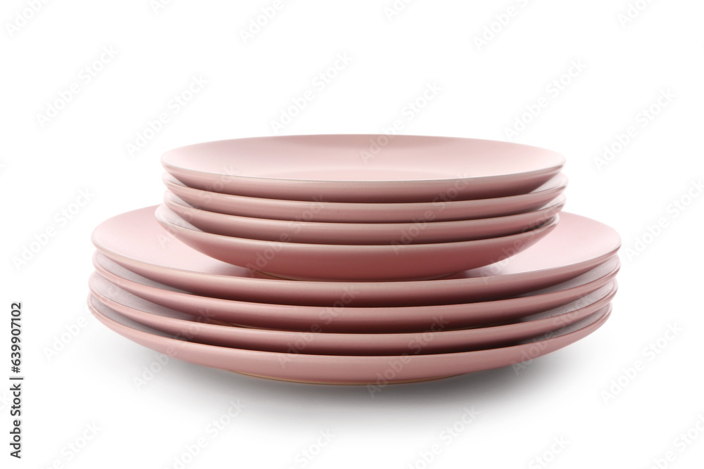Stack of pink plates on white background