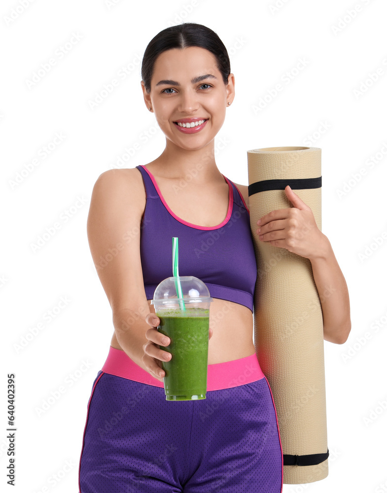 Sporty young woman with healthy smoothie and fitness mat on white background