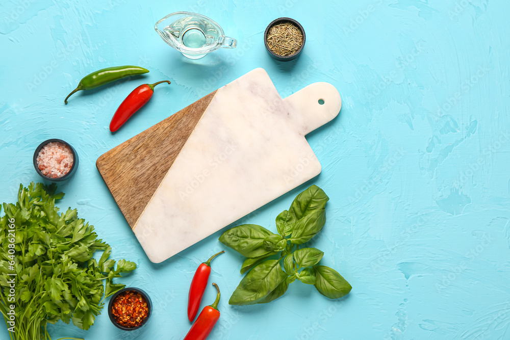 Composition with cutting board, fresh herbs and spices on color background