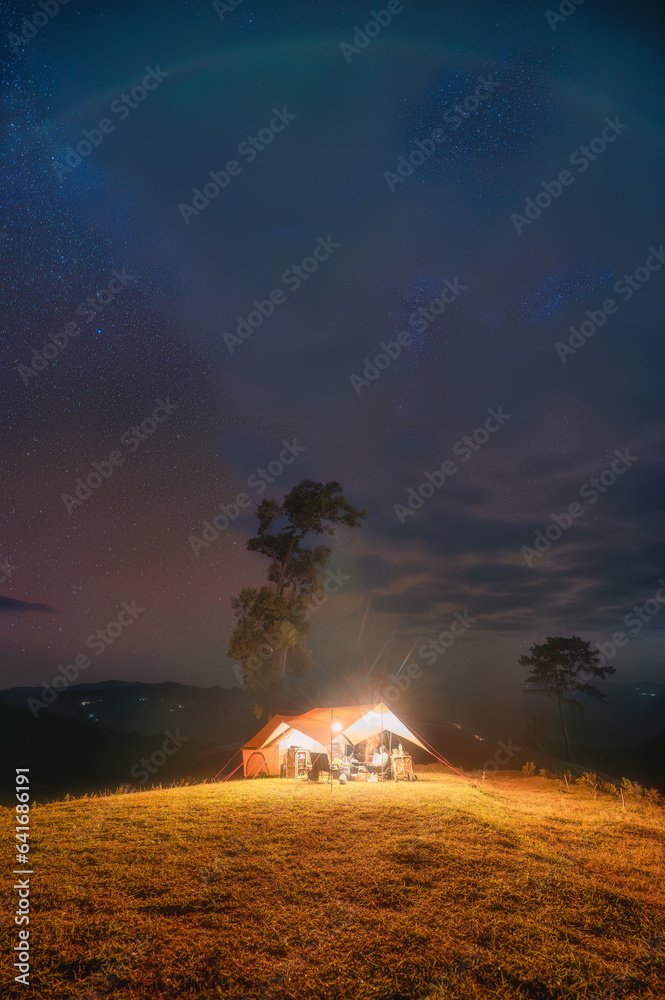 Tent camping with starry on hill in night sky