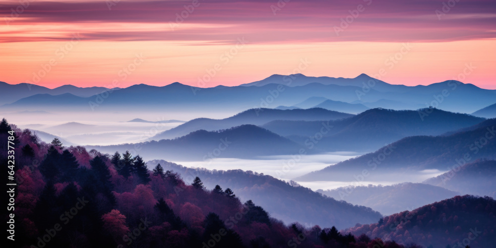 The mountains are shrouded in mist. A twilight shot of autumn mountains under a fading red orange pu