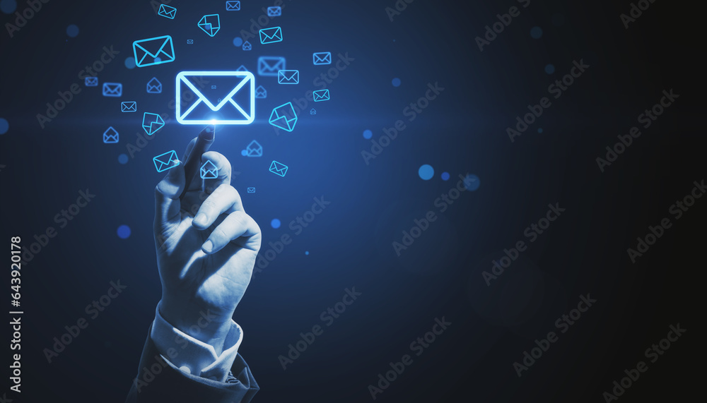 Close up of male hand pointing at glowing email letter icons on dark blue background with mock up pl