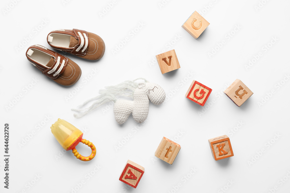 Composition with baby accessories and toys on light background