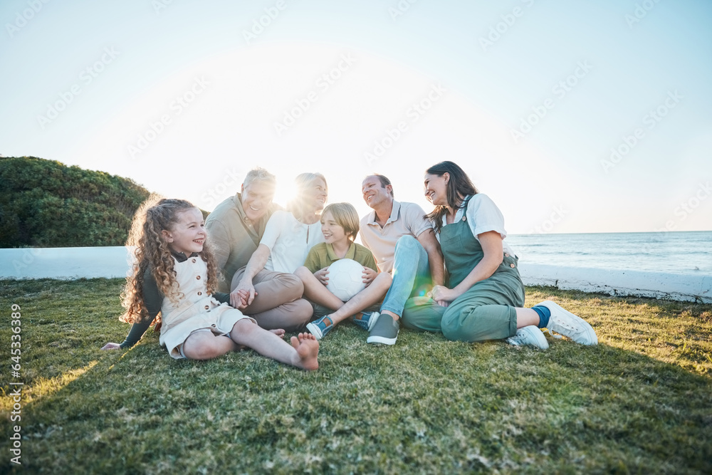 Family, grandparents and children on grass by ocean for bonding, relationship and relax together. Na
