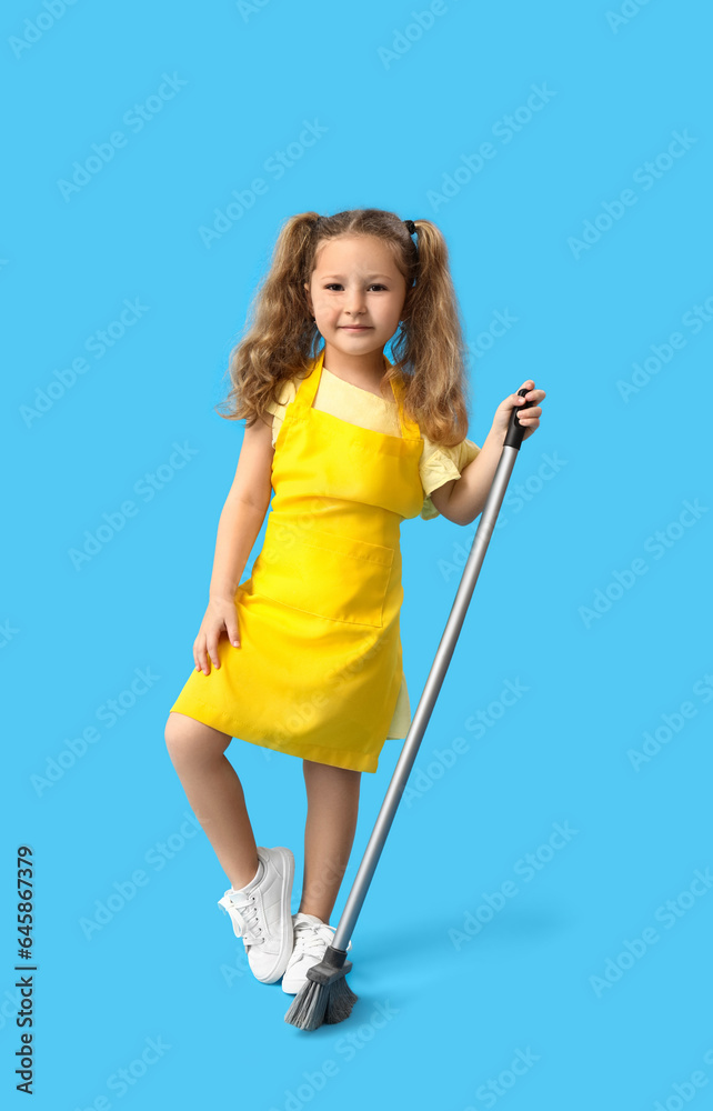 Cute little girl with broom on blue background