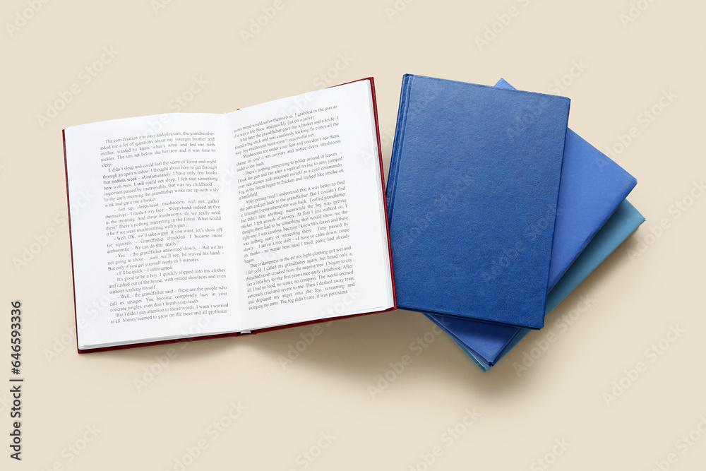 Open and closed books on beige background