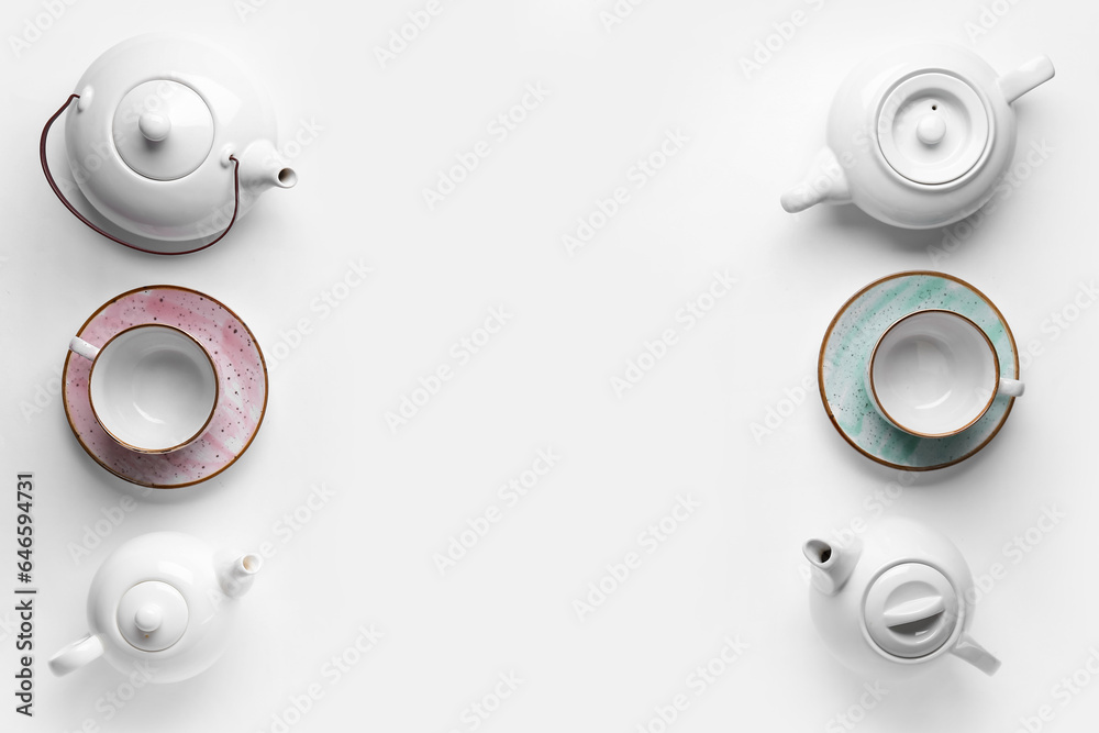 Ceramic teapots and cups on white background