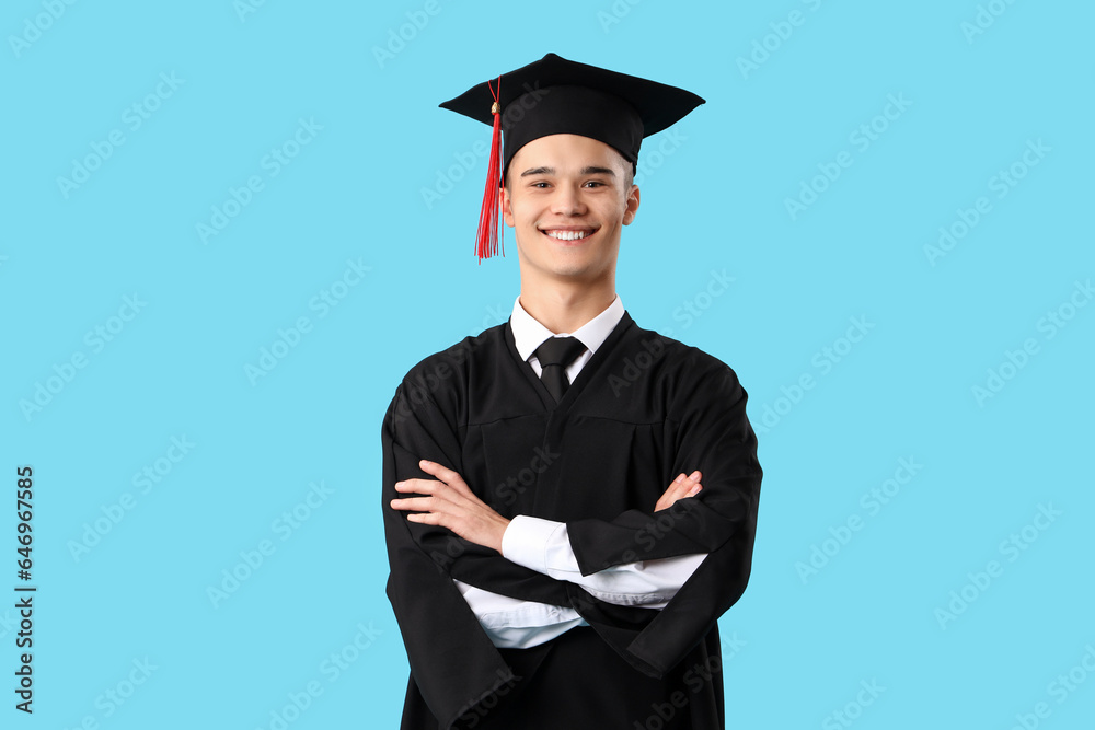 Male graduate student on blue background