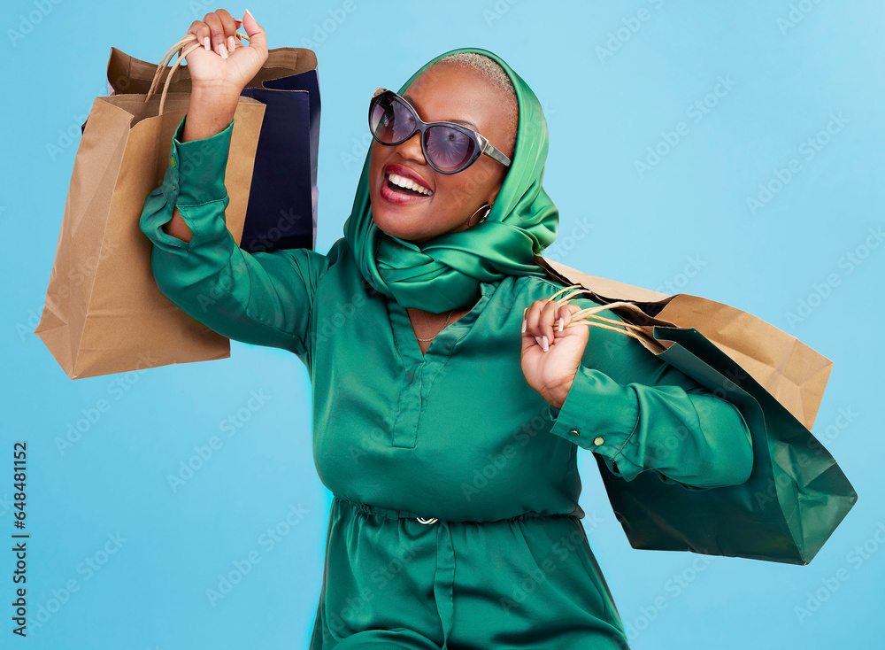 Shopping bag, studio smile and black woman excited for luxury fashion spree, mall store sales or commerce deal. Retail therapy package, market gift choice and rich African customer on blue background