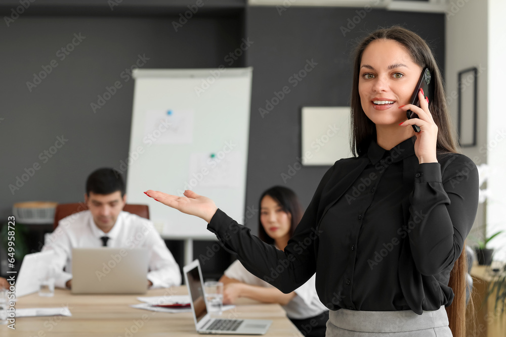 Female business consultant talking call mobile phone in office