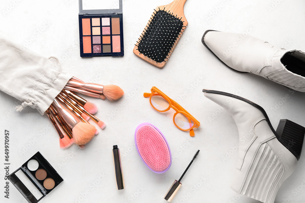 Composition with female accessories, cosmetics and shoes on light background