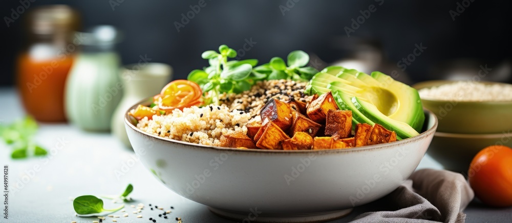 Nutritious vegan Buddha bowl includes quinoa tofu avocado sweet potato brussels sprouts and tahini