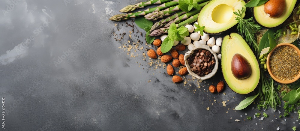 Healthy vegan food including legumes nuts seeds avocado and green peas displayed on a light stone background