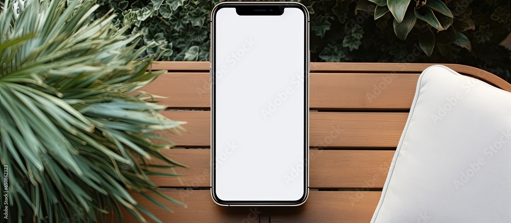 Minimalist mobile phone mockup on vintage chair with blank screen Top view flat lay aesthetic for blogs websites or apps Copy space available