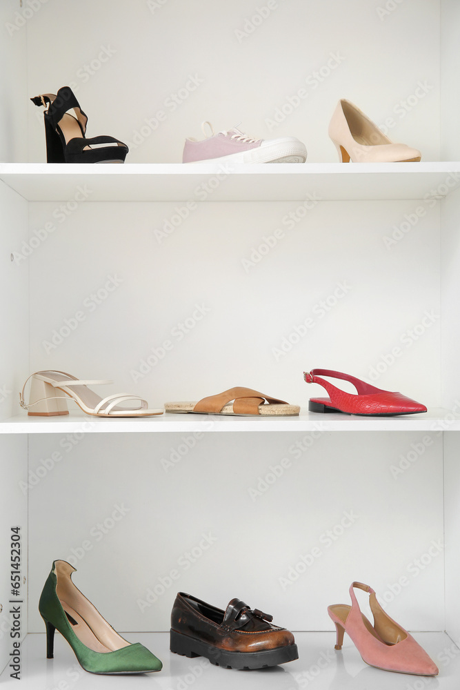 Shelves with different female shoes in boutique
