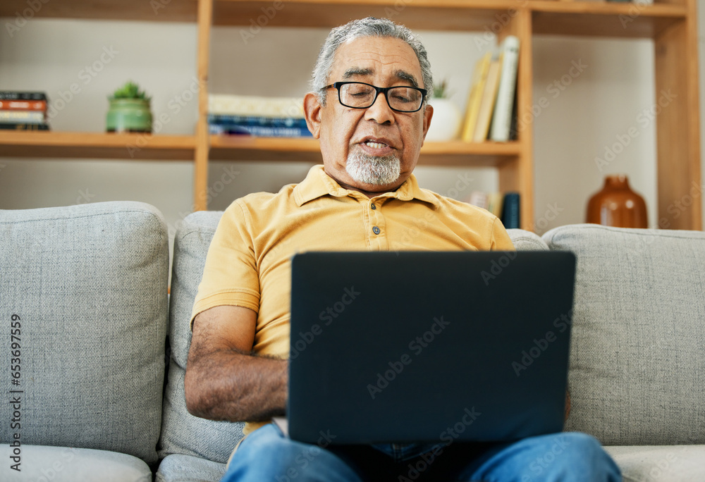 Typing, senior man and laptop on sofa in home with online research in living room or streaming video, movies or tv show. Elderly, person or writing on computer in retirement for blog or communication