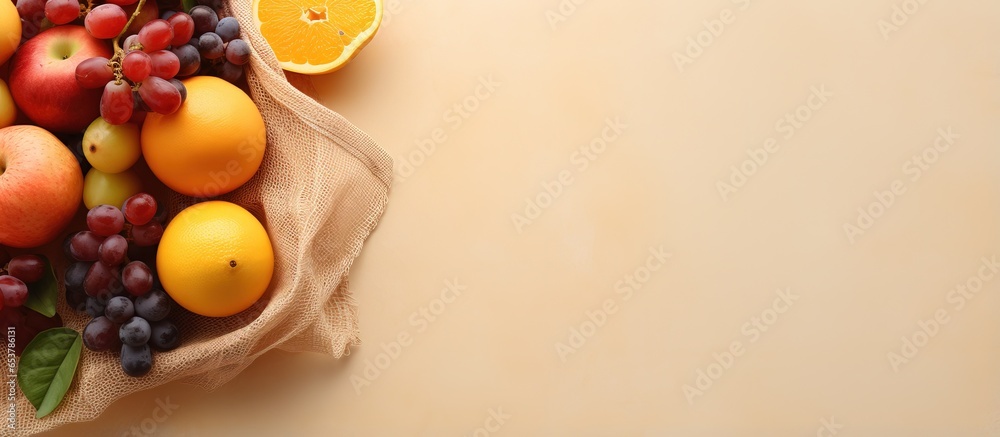 Eco friendly shopping bag with fresh fruits Stylish shadows and sunlight Zero waste beige background top view