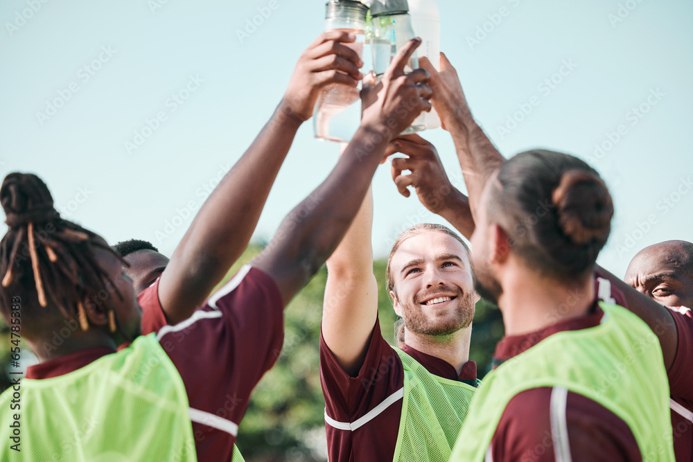 Soccer team, water bottle and toast with teamwork, achievement and support on field. Fitness, workout and sport training of men group with smile and celebration at game outdoor with drink and cheers