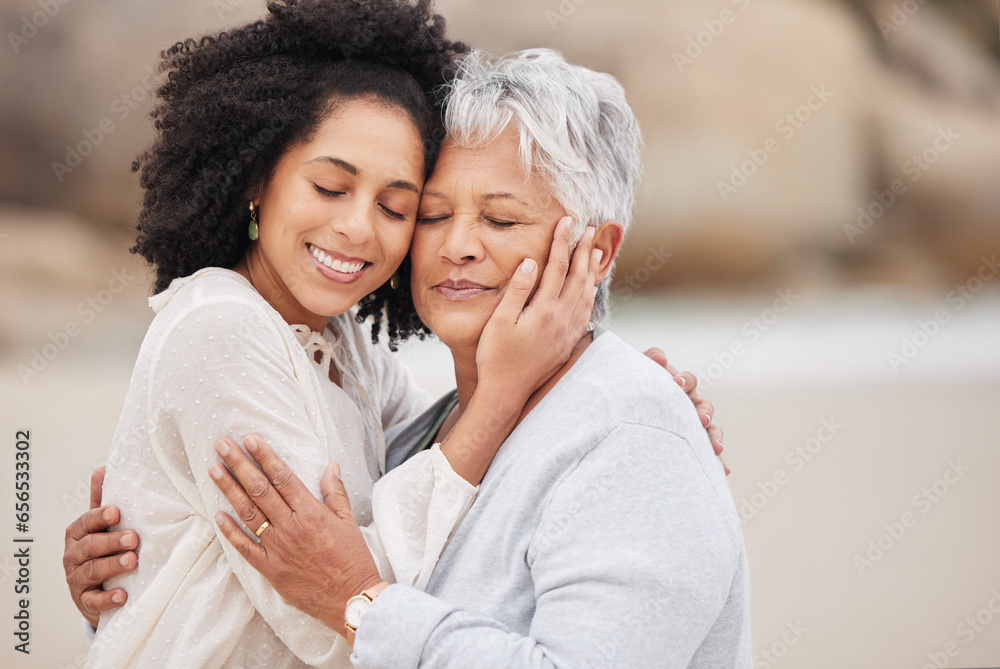 Women, mother and daughter on beach, hugging and smiling in embrace, love and happiness. Family vacation, joy and bonding for retirement, resting and relaxation on ocean, enjoying and quality time