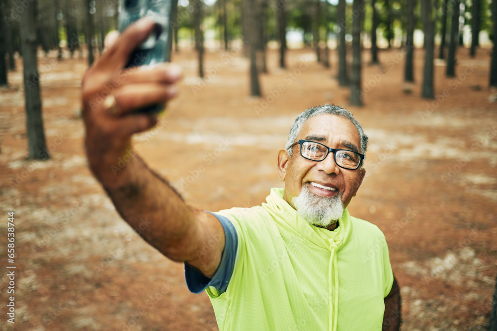Selfie, smile and senior man hiking for health, wellness or cardio training on a mountain. Happy, nature and excited elderly male person taking a picture on cellphone for outdoor trekking in woods.