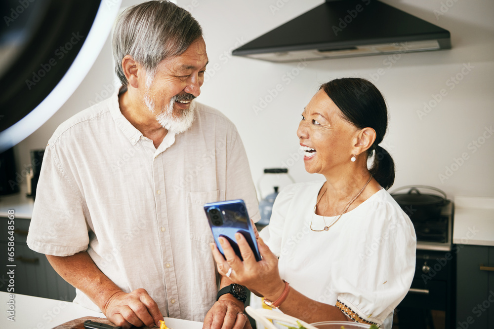 Home, influencer and senior couple with a smartphone, social media and connection with conversation. Kitchen, elderly man or old woman with a cellphone, content creation and digital app with internet