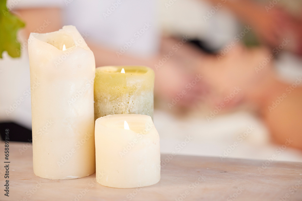 Zen, table and candles at spa during massage for relax, wellness and lighting at a hotel. Calm, peace and a flame in a room for a luxury treatment, aroma therapy or ambient experience for hospitality