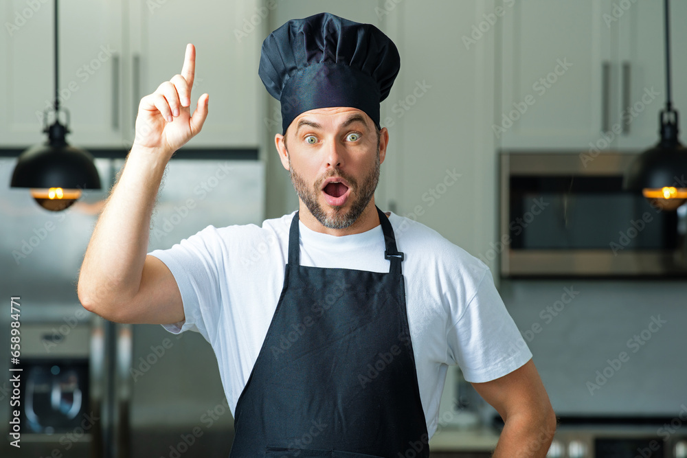 Idea for food. Handsome man chef in uniform cooking in the kitchen. Restaurant menu concept. Hispanic man in baker uniform. Cooking and culinary. Male chef in working uniform, black apron, chef hat.