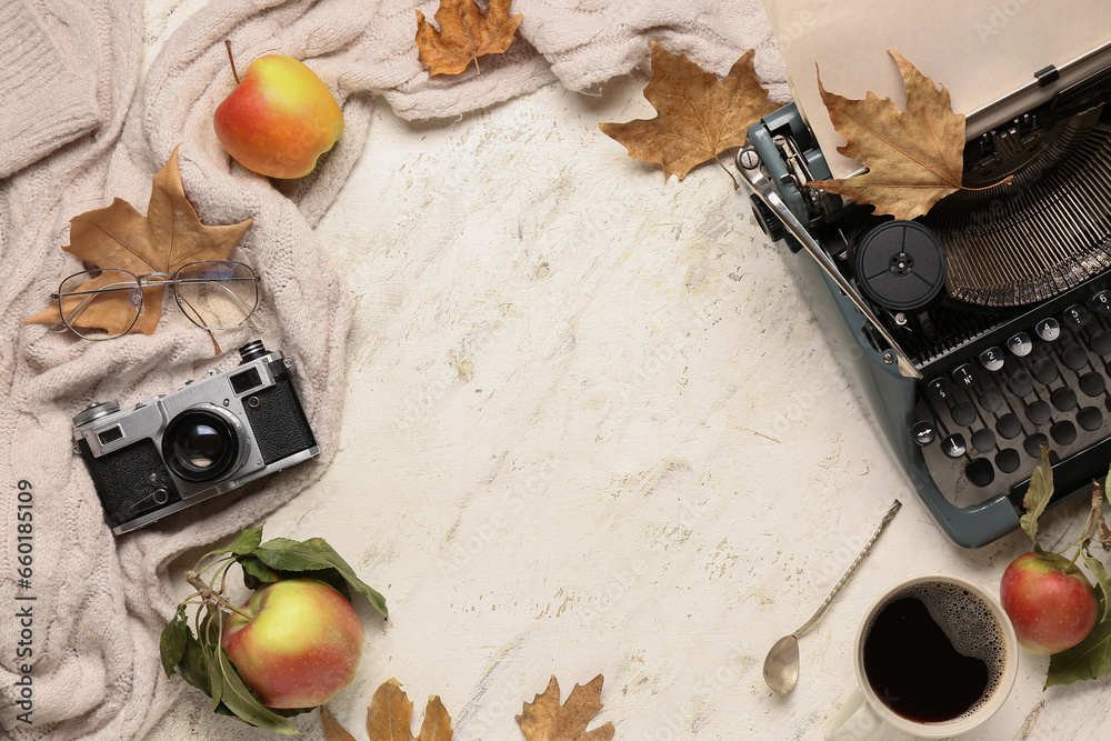 Frame made of vintage typewriter, apples, photo camera, cup with coffee, eyeglasses and autumn leaves on white background
