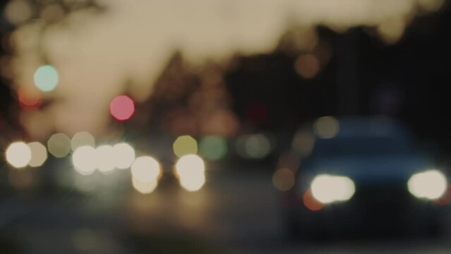 Car traffic at dusk, car headlights in blur. 