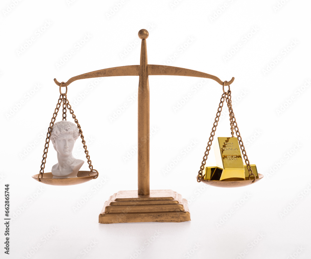 The balance holds gold bar and sculpture