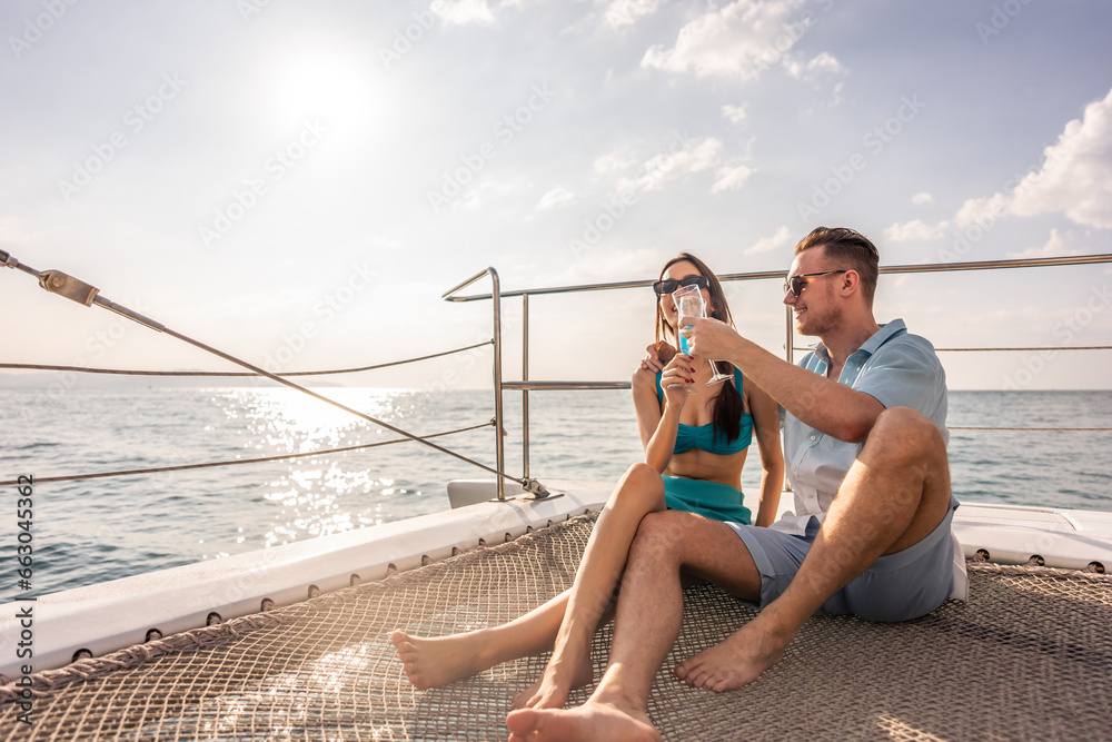 Young romantic couple looking at beautiful view during yachting. 