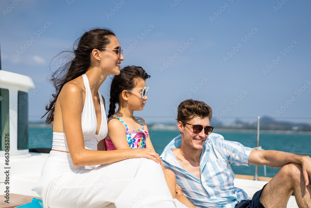 Caucasian happy family sitting on deck of yacht while yachting outdoor. 