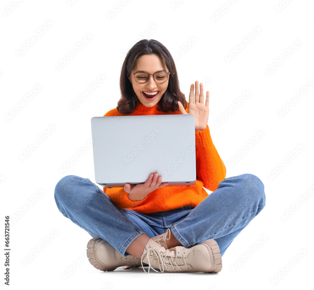 Young woman using laptop on white background