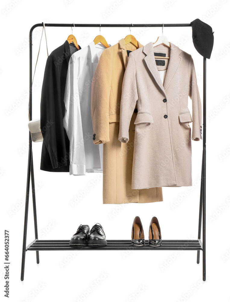 Rack with stylish clothes, shoes and accessories on white background