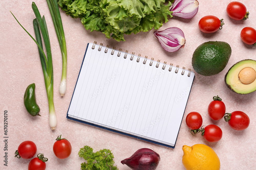 Composition with blank recipe book and fresh vegetables on color background