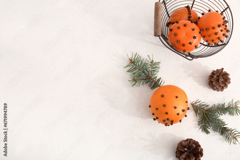 Basket with pomander balls and Christmas tree branches on white background