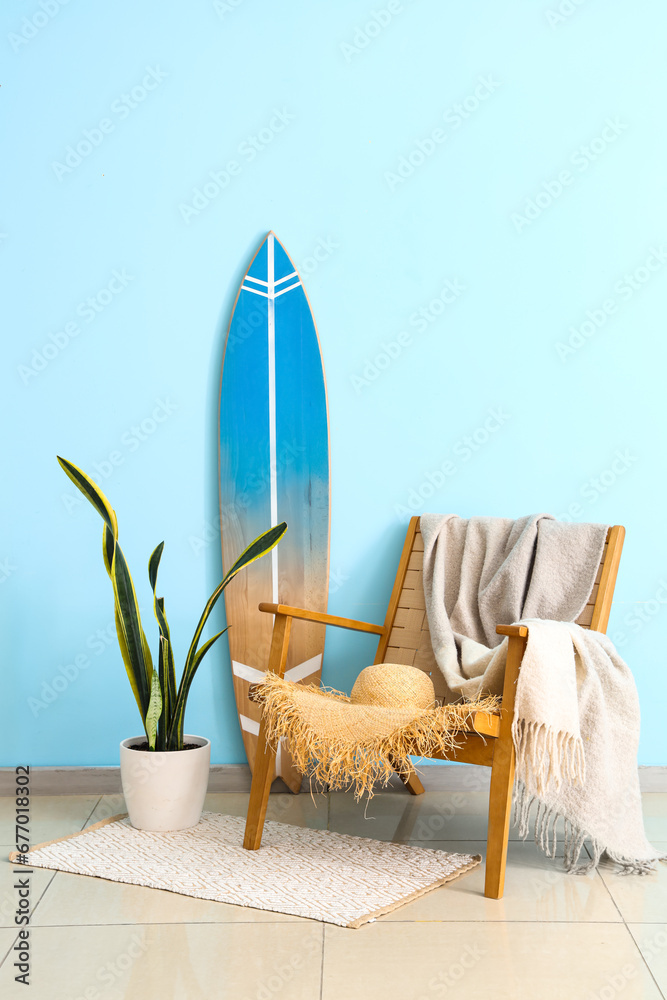 Interior of living room with surfboard and plaid on armchair