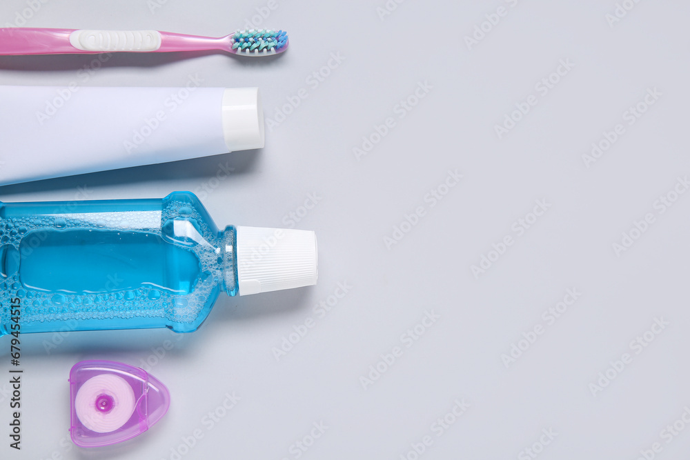 Simple set for oral hygiene on grey background.