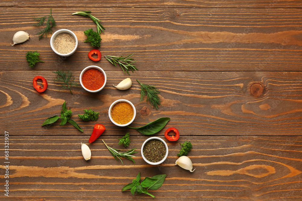 Composition with different spices and herbs on wooden background