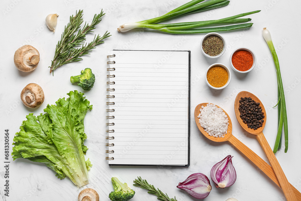 Composition with blank recipe book, fresh herbs and spices on light background