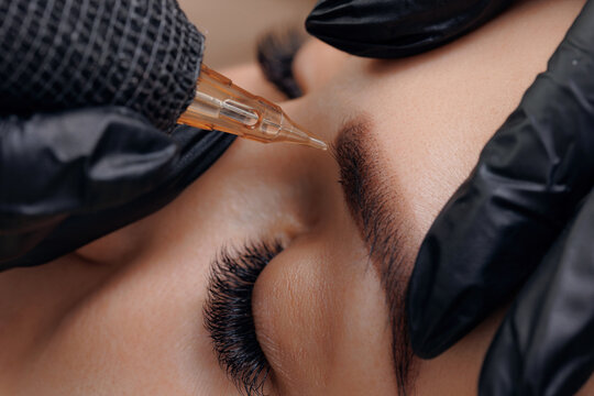 Detail of beautiful woman with black brows in beauty salon. Procedure Permanent makeup tattoo for eyebrows
