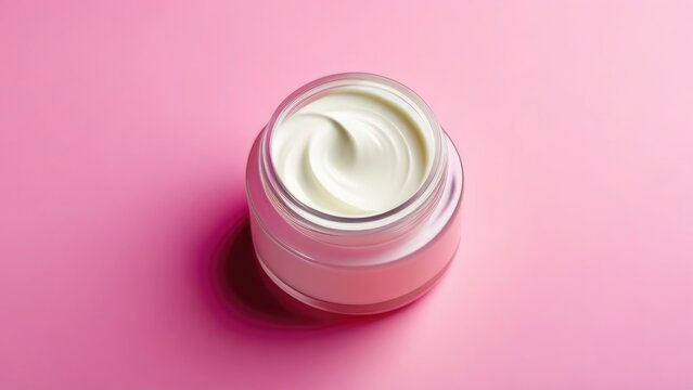 Jar of cosmetic cream on solid pink background, top view. Space for text, empty space. Mask for face.