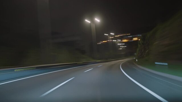 Timelapse of a speedy night drive trip through the Madeira tunnels. View from the car windshield to the road. Hyperlapse road trip sort of dashcam POV. Travel Concept Madeira island