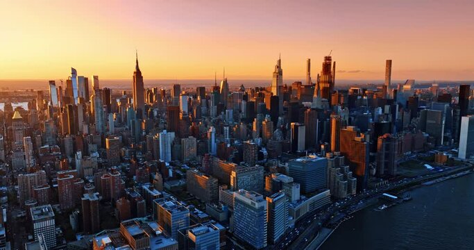 Golden hour in modern New York, United States. Aerial perspective on city scenery from top at sunset.