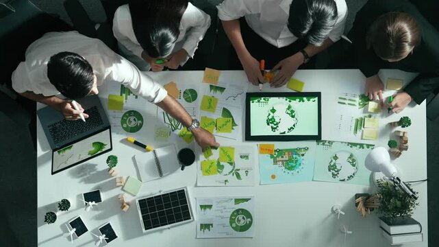 Top view of executive manager hold tablet display clean energy at meeting. Aerial view of business people working together to plan and invest in sustainable environmental investment. Alimentation.