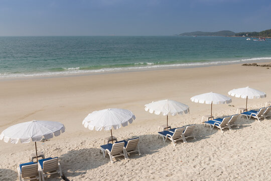 Row of chairs and umbrellas on the white sand beach Thailand
