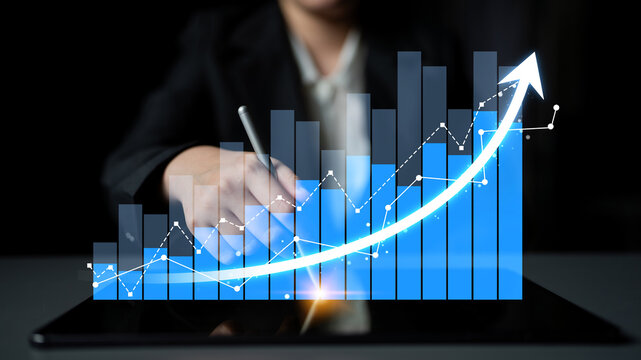 A business professional reviews data trends and growth projections using a digital tablet in a modern workspace, highlighting the importance of analytics for success. Scalp