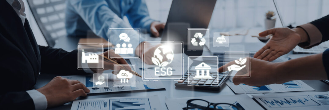 A dynamic business meeting focusing on ESG strategies captures professionals discussing sustainability and responsible investment in a modern office environment. Trope