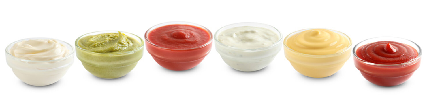 Different condiments. Sauces in bowls isolated on white, set